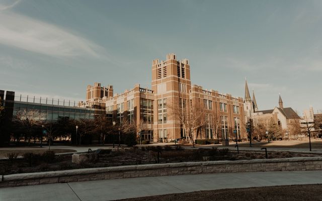 A brick collegiate building and open plaza on a winter afternoon