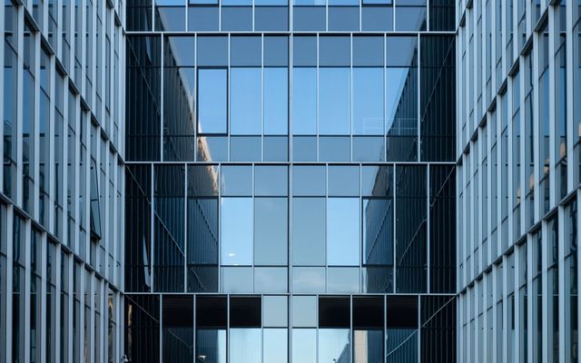 Mirrored glass office facades facing each other across a narrow courtyard