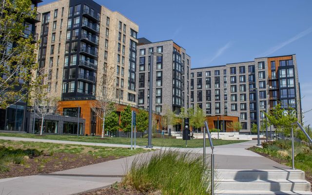 A mid-rise apartment complex with new landscaping and walkways