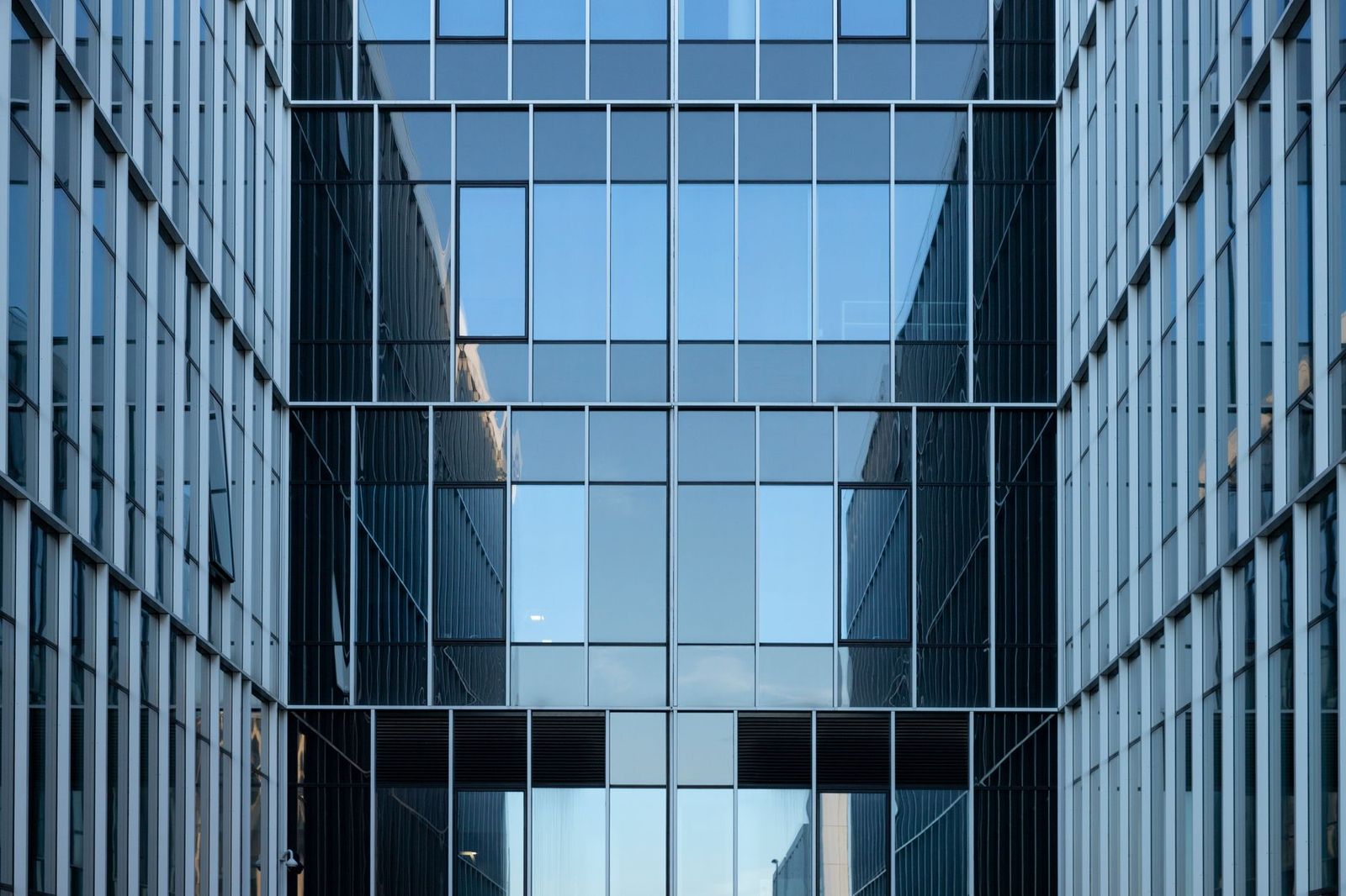 Mirrored glass office facades facing each other across a narrow courtyard