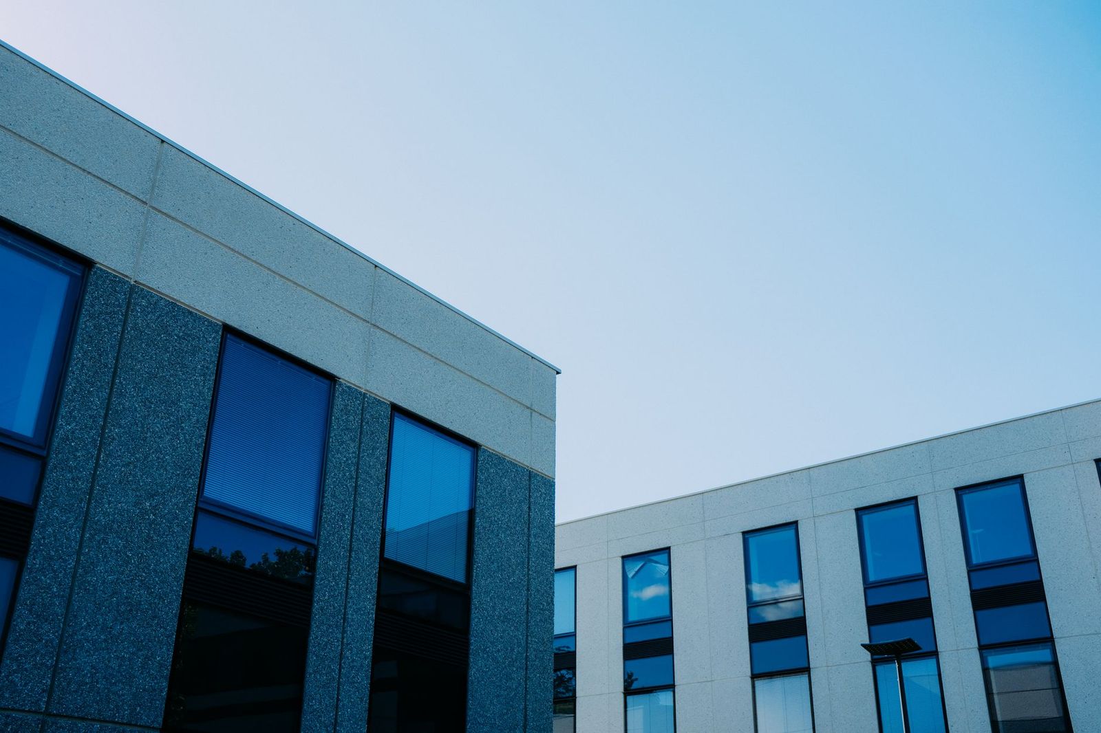 Two stone-and-glass medical office buildings against a clear evening sky
