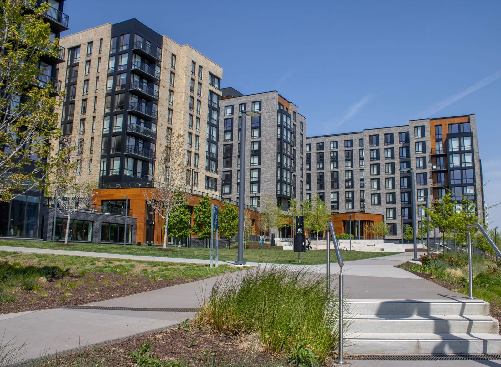 A mid-rise apartment complex with new landscaping and walkways