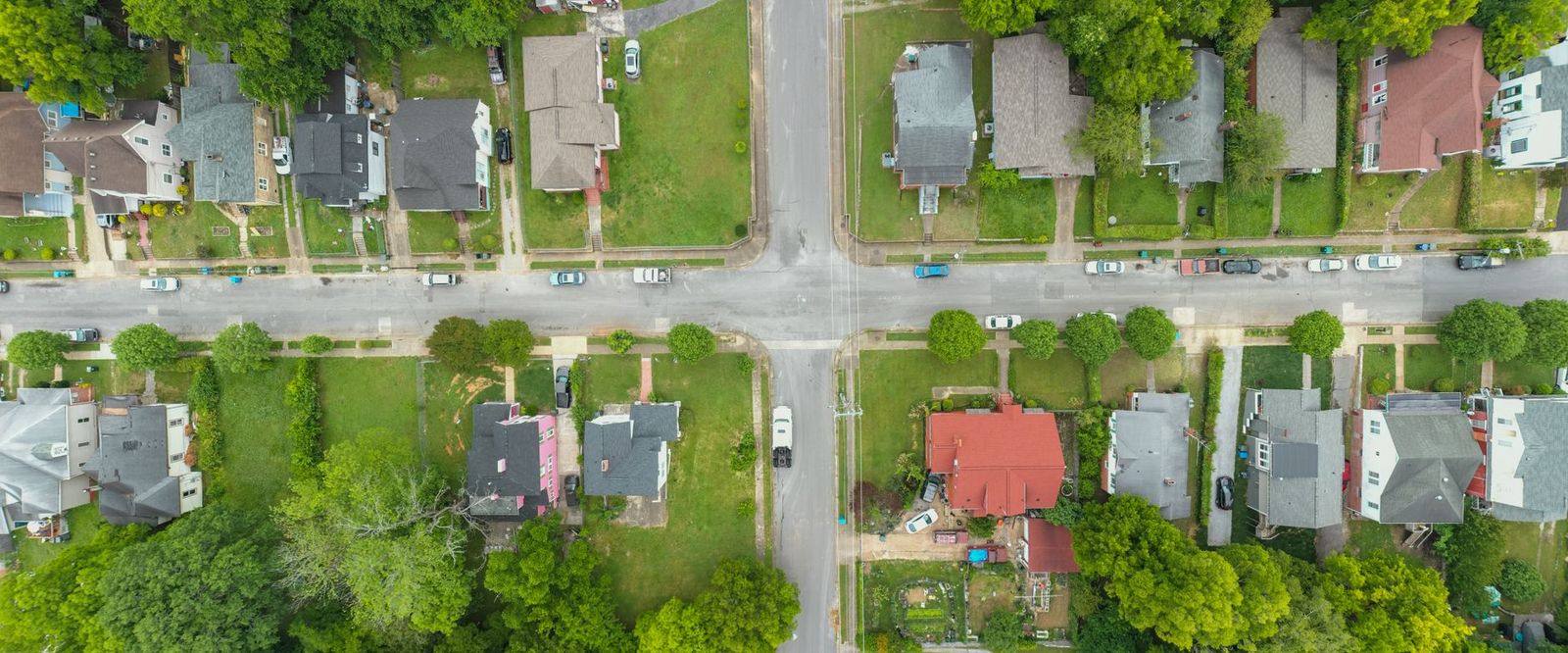 A straight-down aerial view of suburban blocks, yards and intersecting streets